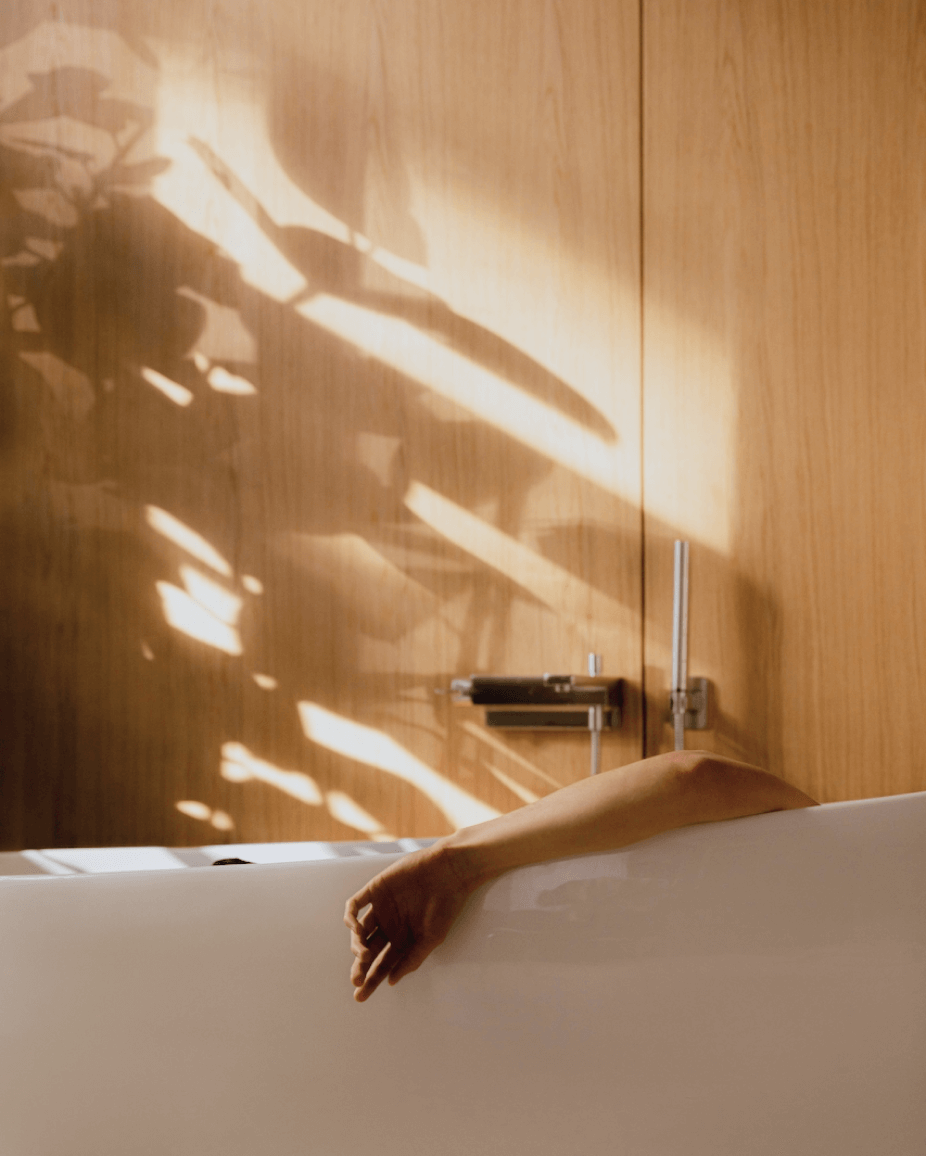 Close up relaxed person lying in bathtub